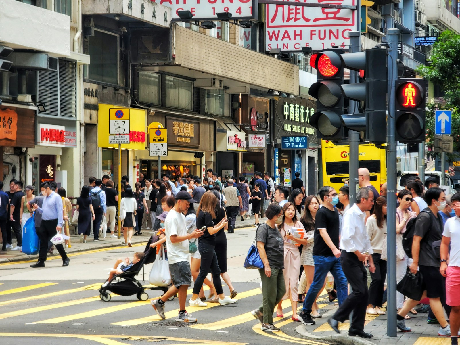 People crossing a busy shopping street in Hong Kong